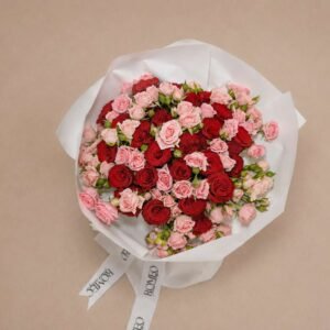 Mixed red and pink roses bouquet top view in white wrap by Romeo Flower Boutique